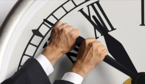 hands stopping large clock